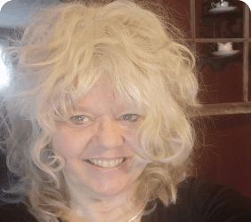 Jodi, a tarot and spirit insights advisor, smiling to camera.